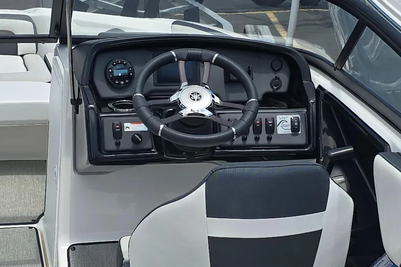 Slide: The Image of 2022 Yamaha AR195 boat cockpit with steering wheel and control panel. - 8