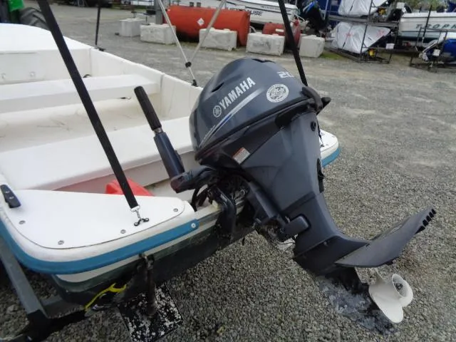 Slide: The Image of Small boat with Yamaha outboard motor, Sundance K14T model, 2010, on gravel surface. - 10