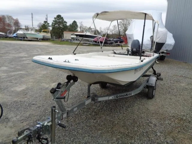 Slide: The Image of Sundance K14T 2010 boat on trailer with canopy, parked outdoors. - 4