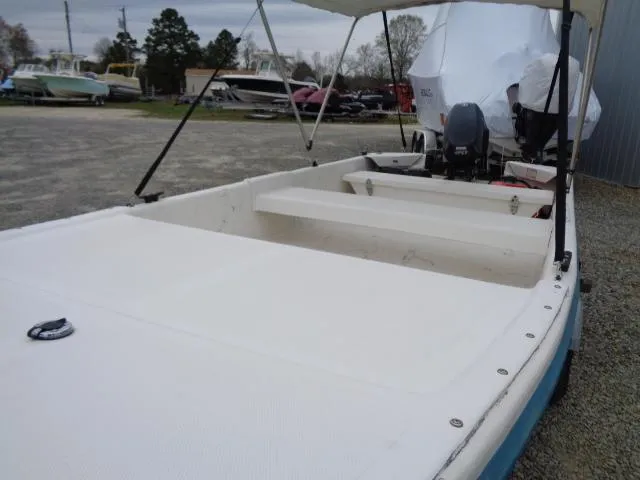 Slide: The Image of 2010 Sundance K14T boat with outboard motor in a gravel lot. - 5