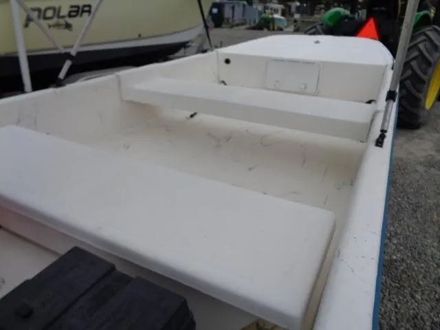 Slide: The Image of White Sundance K14T boat interior, 2010 model, with bench seating and storage compartments. - 8