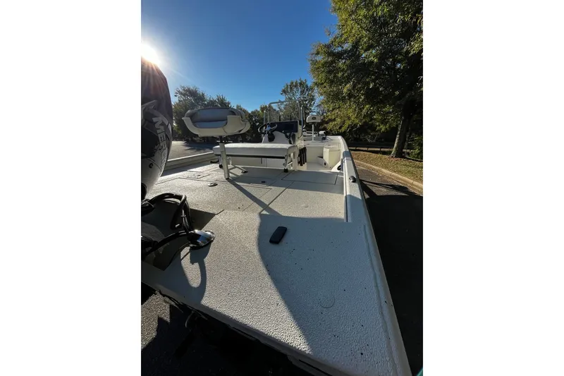 Slide: The Image of 2025 Ranger RB210 boat on a sunny day, parked near trees. - 4