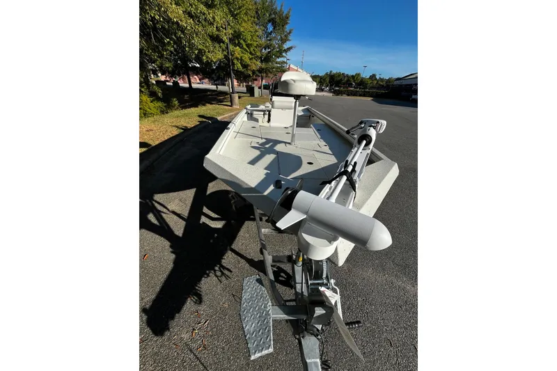 Slide: The Image of 2025 Ranger RB210 boat on trailer, parked outdoors under clear blue sky. - 6