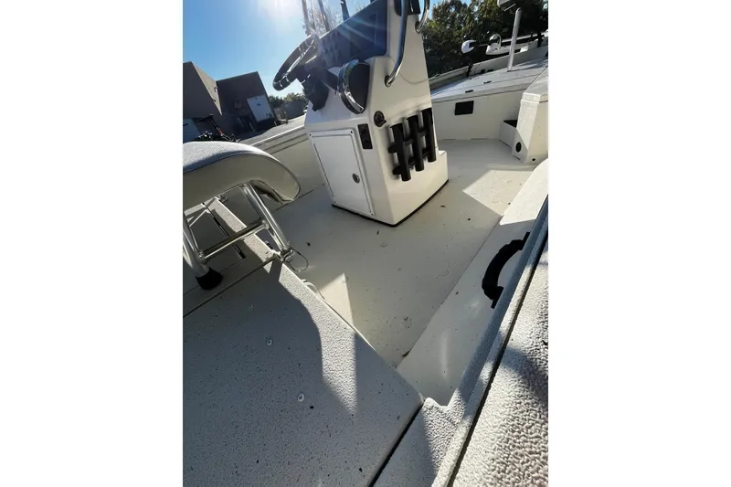 Slide: The Image of 2025 Ranger RB210 boat interior with steering console and seating under bright sunlight. - 7