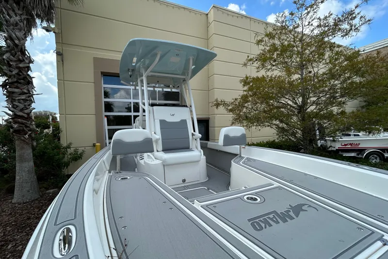 Slide: The Image of 2025 Mako 24 APEX boat displayed outdoors, featuring sleek design and modern seating. - 8
