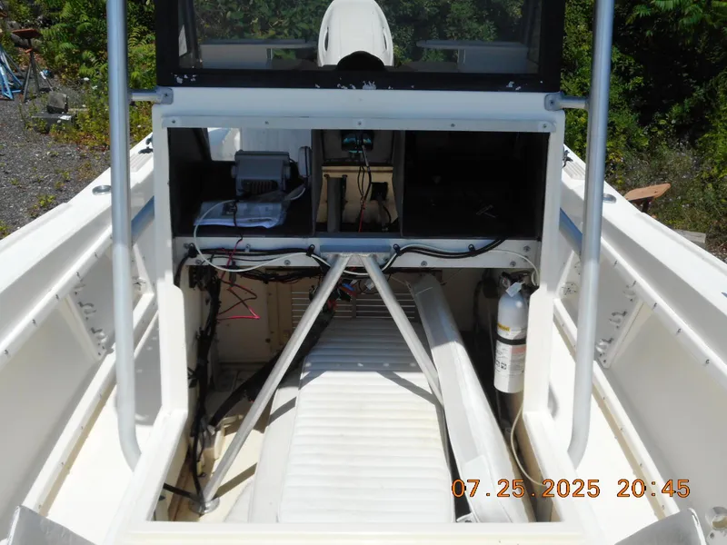 Slide: The Image of 1992 Mako 22 CC boat interior with console and equipment, photographed outdoors. - 12