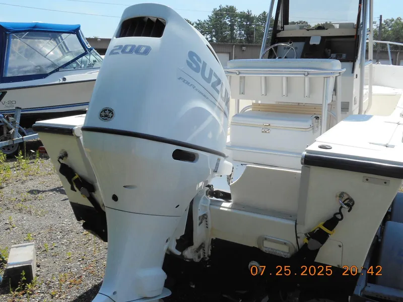 Slide: The Image of 1992 Mako 22 CC boat with Suzuki 200 outboard motor, docked outdoors. - 4