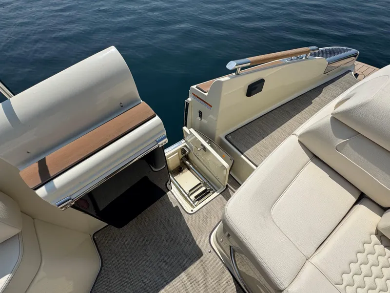Slide: The Image of 2022 Chris-Craft Launch 28 GT boat interior with seating and open storage compartment. - 10