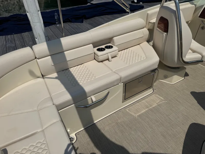 Slide: The Image of 2022 Chris-Craft Launch 28 GT boat interior with beige seating and cup holders. - 12