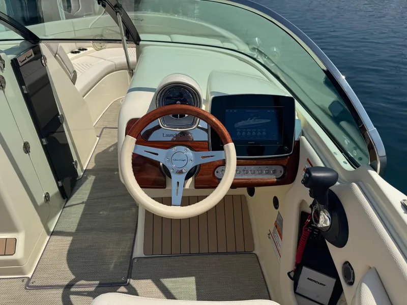 Slide: The Image of 2022 Chris-Craft Launch 28 GT cockpit with steering wheel and dashboard display. - 15