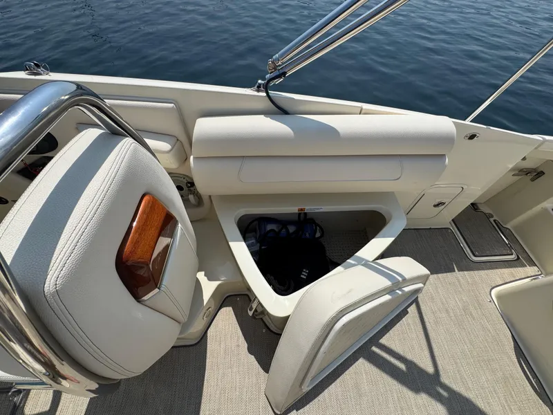 Slide: The Image of 2022 Chris-Craft Launch 28 GT boat interior with open storage compartment and seating. - 18