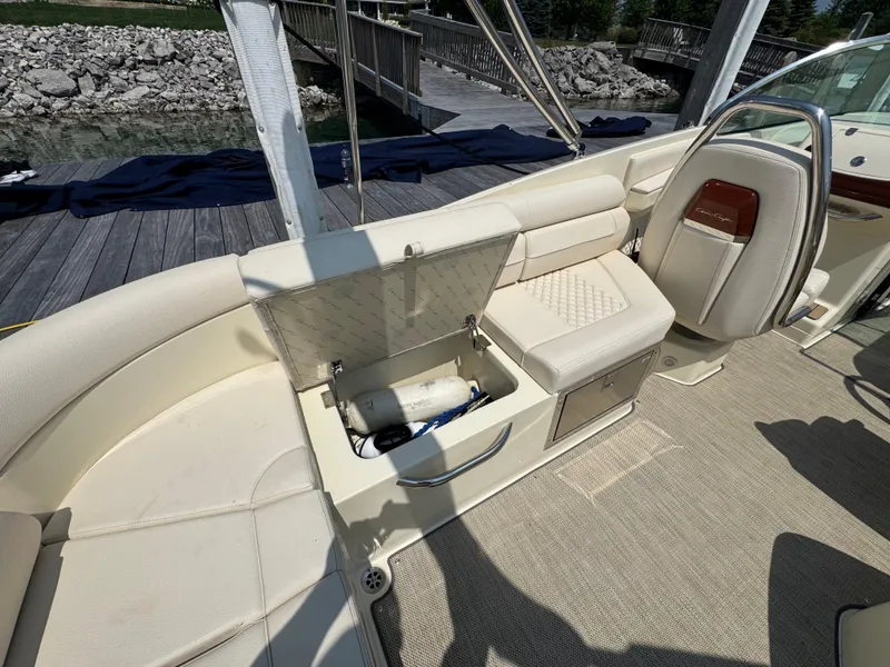 Slide: The Image of 2022 Chris-Craft Launch 28 GT interior with open storage compartment and luxurious seating. - 19