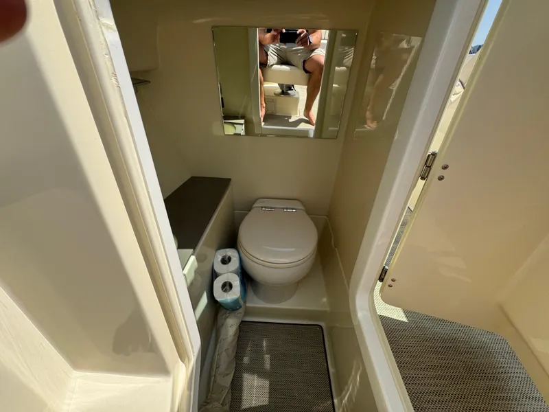 Slide: The Image of 2022 Chris-Craft Launch 28 GT boat bathroom interior with toilet and mirror. - 20