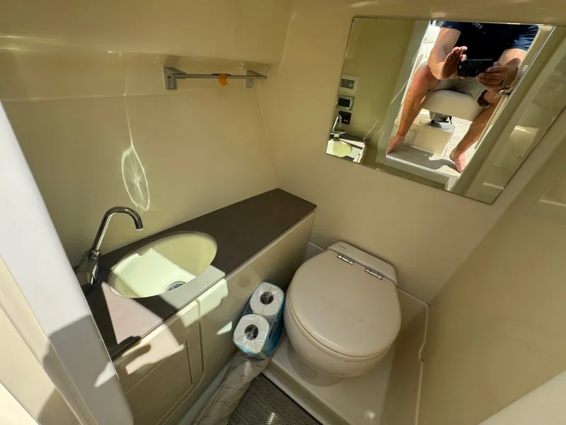 Slide: The Image of 2022 Chris-Craft Launch 28 GT boat bathroom with sink, toilet, and mirror. - 21