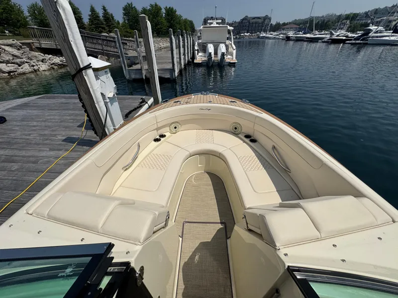 Slide: The Image of 2022 Chris-Craft Launch 28 GT boat docked at marina, featuring luxurious seating. - 22