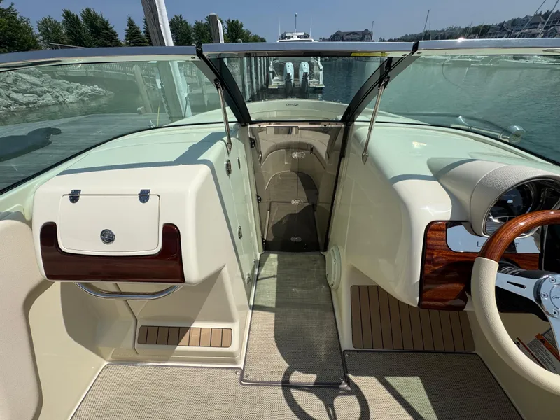 Slide: The Image of 2022 Chris-Craft Launch 28 GT interior with elegant dashboard and steering wheel. - 23