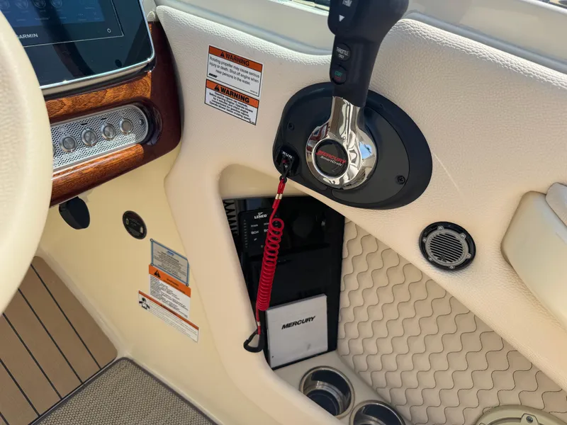 Slide: The Image of 2022 Chris-Craft Launch 28 GT boat interior with Mercury controls and Garmin display. - 26