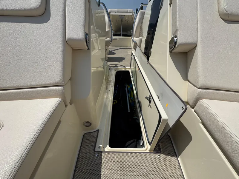 Slide: The Image of 2022 Chris-Craft Launch 28 GT interior storage compartment with open hatch, showcasing spacious design. - 27
