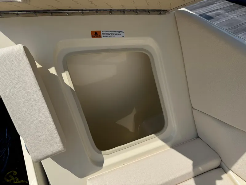 Slide: The Image of 2022 Chris-Craft Launch 28 GT interior storage compartment with warning label. - 28
