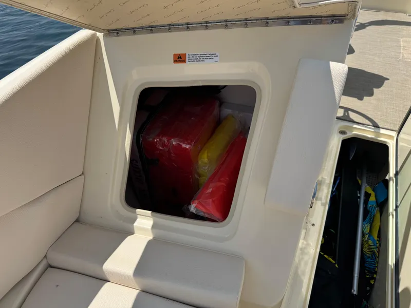 Slide: The Image of 2022 Chris-Craft Launch 28 GT storage compartment with life jackets and equipment. - 29