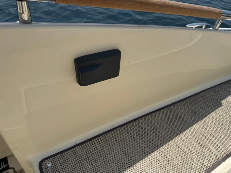 Slide: The Image of 2022 Chris-Craft Launch 28 GT boat deck with wooden railing and textured flooring. - 33