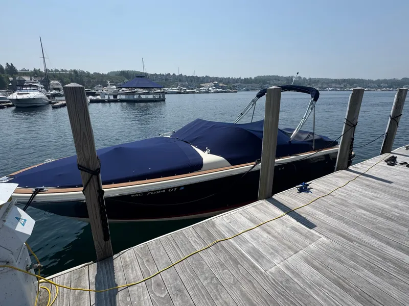 Slide: The Image of 2022 Chris-Craft Launch 28 GT docked at a marina, covered and ready for use. - 35