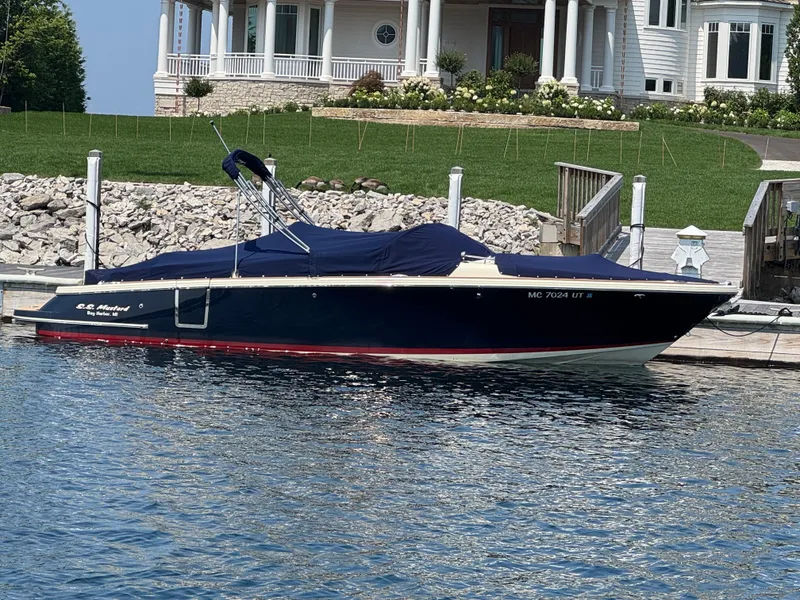 Slide: The Image of 2022 Chris-Craft Launch 28 GT boat docked by a waterfront home. - 36