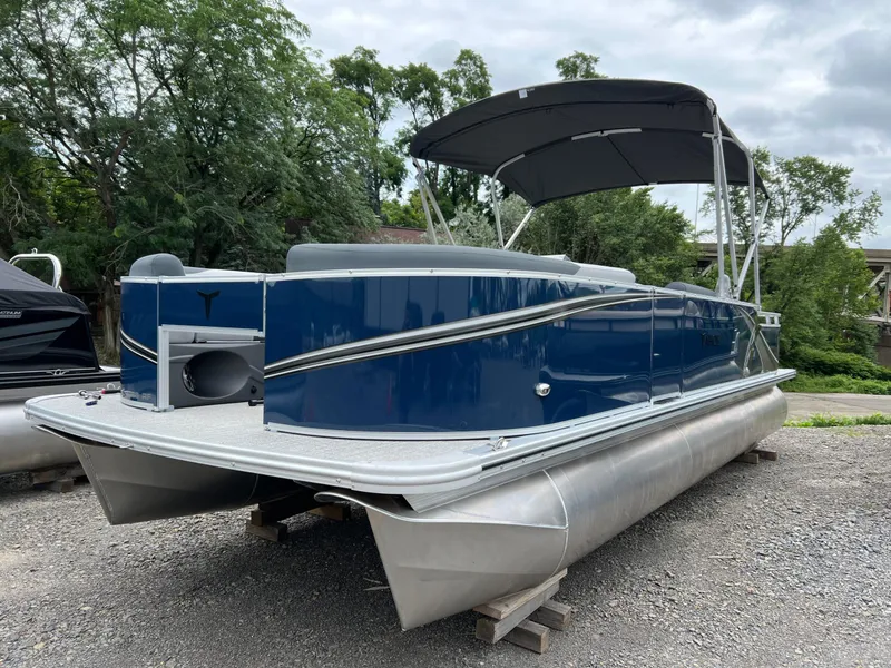 The Image of 2026 Tahoe Pontoon LTZ 2385 RF, blue, parked on gravel with trees in background. - 1