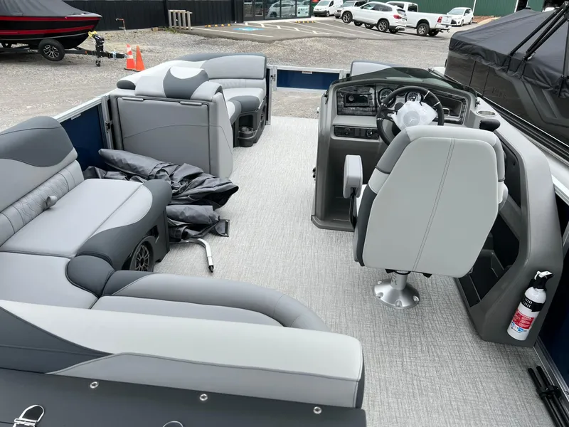 Slide: The Image of 2026 Tahoe Pontoon LTZ 2385 RF interior with gray seating and modern dashboard. - 13