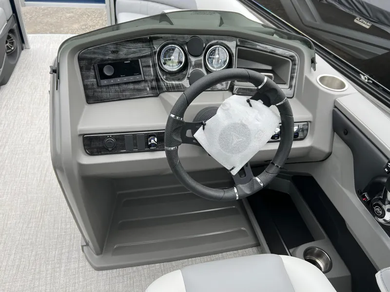 Slide: The Image of 2026 Tahoe Pontoon LTZ 2385 RF dashboard with steering wheel and modern controls. - 17