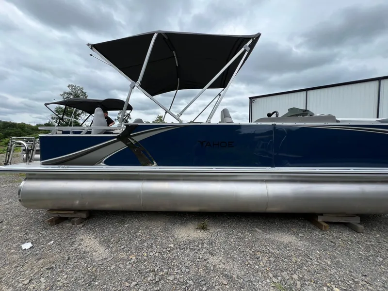 Slide: The Image of 2026 Tahoe Pontoon LTZ 2385 RF with canopy, parked on gravel. - 5