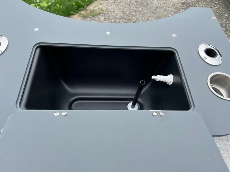 Slide: The Image of 2026 Tahoe Pontoon LTZ 2385 RF storage compartment with cup holders and fittings. - 9