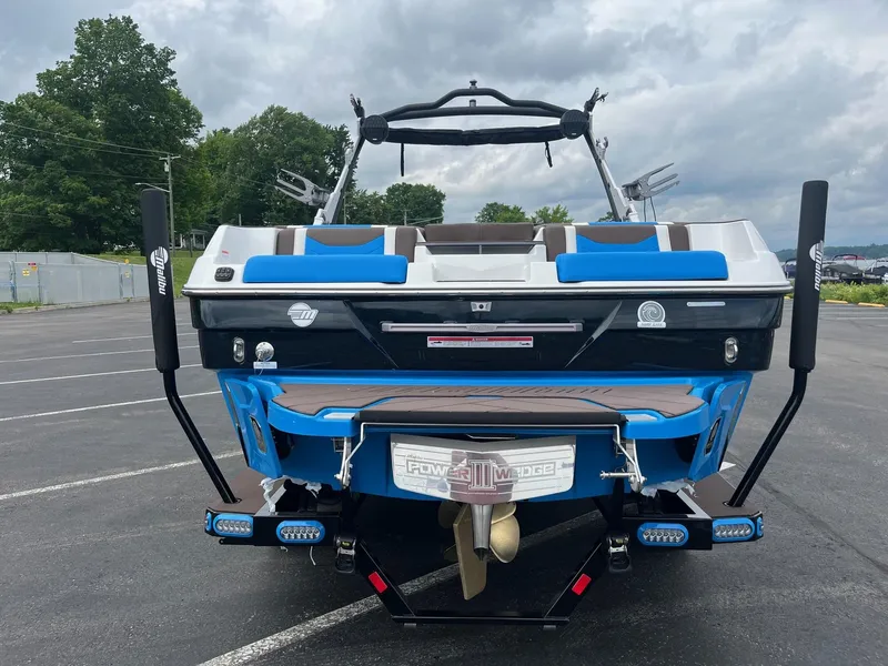 Slide: The Image of 2025 Malibu Wakesetter 23 LSV boat, rear view, in a parking lot. - 4