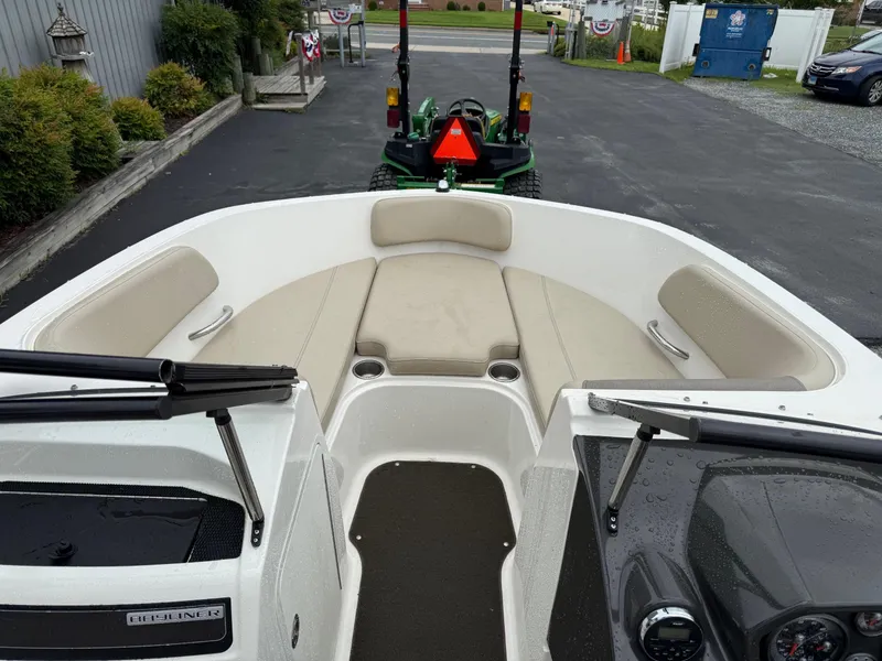 Slide: The Image of 2016 Bayliner VR5 Bowrider interior with beige seating and dashboard view. - 11