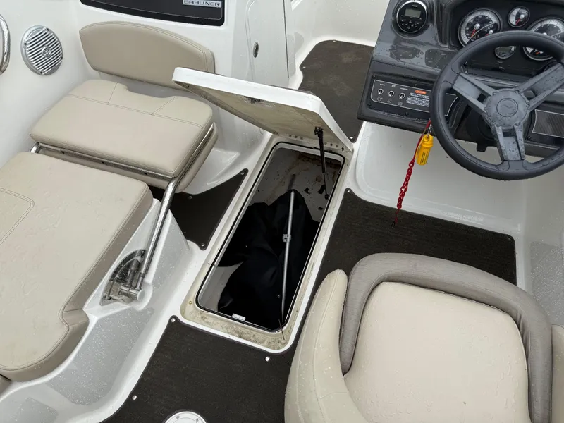 Slide: The Image of 2016 Bayliner VR5 Bowrider interior with open storage compartment and steering wheel. - 13