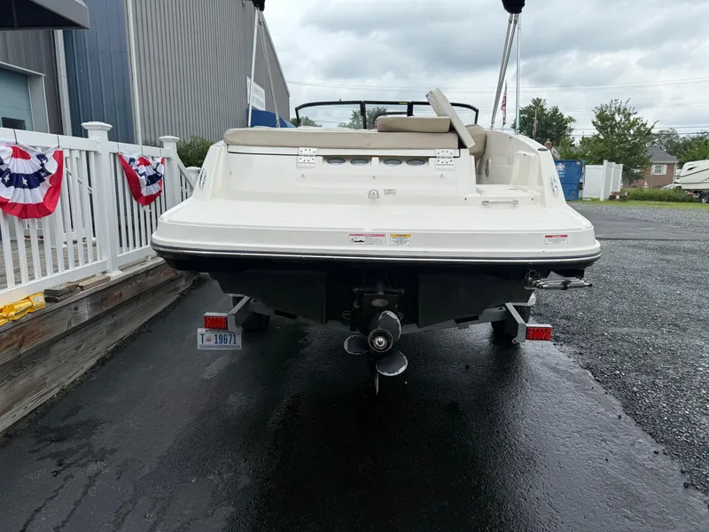 Slide: The Image of 2016 Bayliner VR5 Bowrider boat, rear view, parked on a trailer near a building. - 3