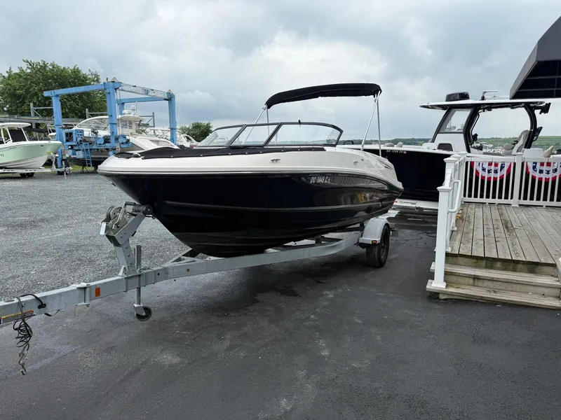 Slide: The Image of 2016 Bayliner VR5 Bowrider on trailer, parked at marina with overcast sky. - 5