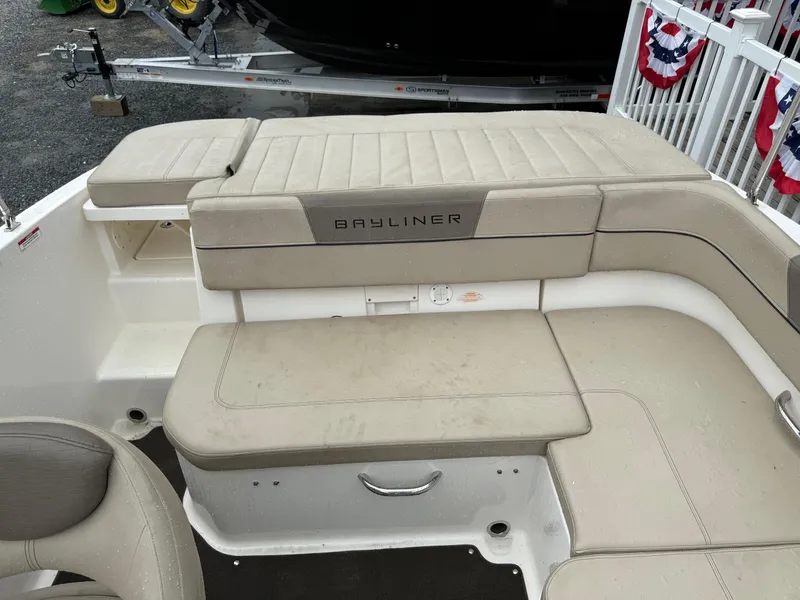 Slide: The Image of 2016 Bayliner VR5 Bowrider boat interior with beige seating and storage compartments. - 6