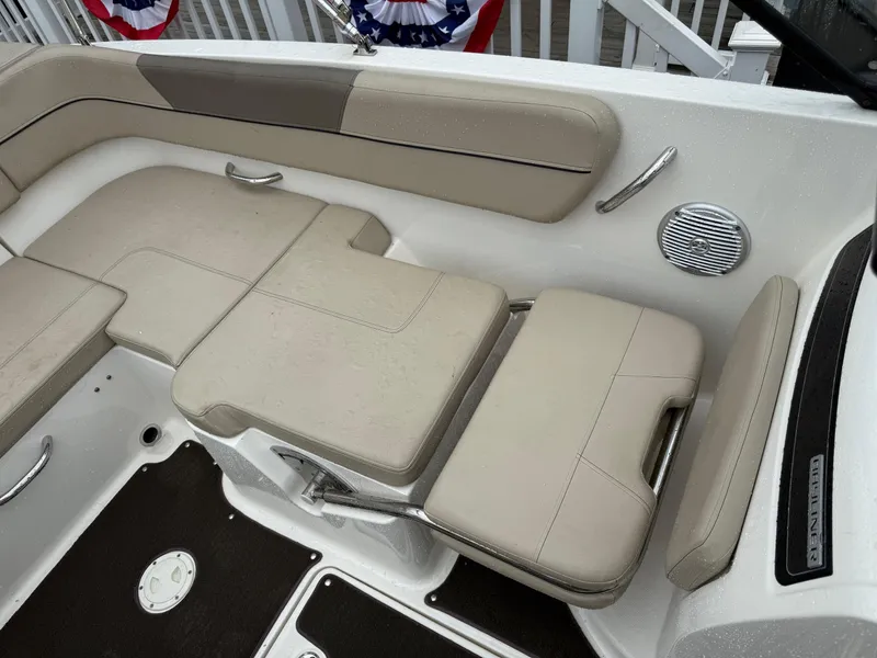 Slide: The Image of 2016 Bayliner VR5 Bowrider interior seating with beige cushions and stainless steel accents. - 7