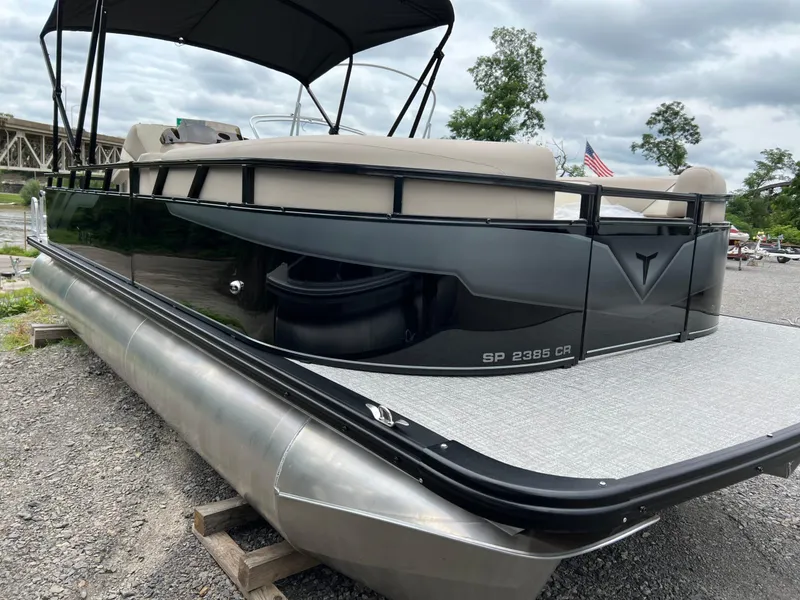 Slide: The Image of 2026 Tahoe Pontoon SPORT 85 2385 CRUISE on gravel, featuring sleek design and canopy. - 5