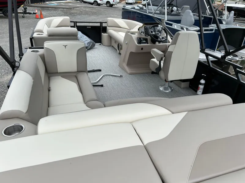 Slide: The Image of 2026 Tahoe Pontoon SPORT 85 2385 CRUISE interior with beige seating and steering console. - 6