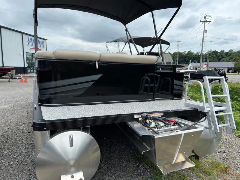 Slide: The Image of 2026 Tahoe Pontoon SPORT 85 2385 CRUISE, black exterior, docked with ladder and canopy. - 7