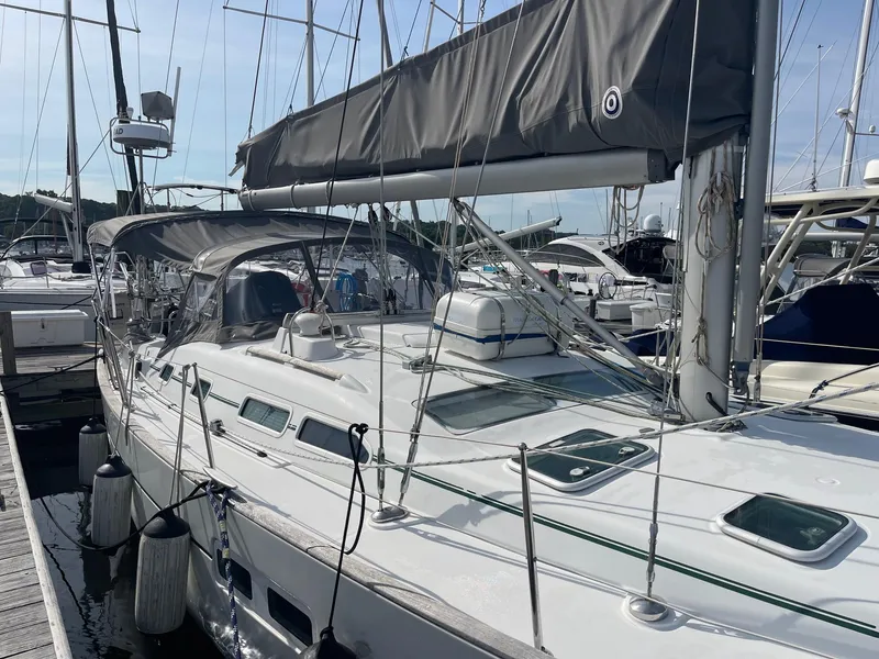 Slide: The Image of 2003 Beneteau 423 sailboat docked at marina, featuring sleek design and modern rigging. - 1