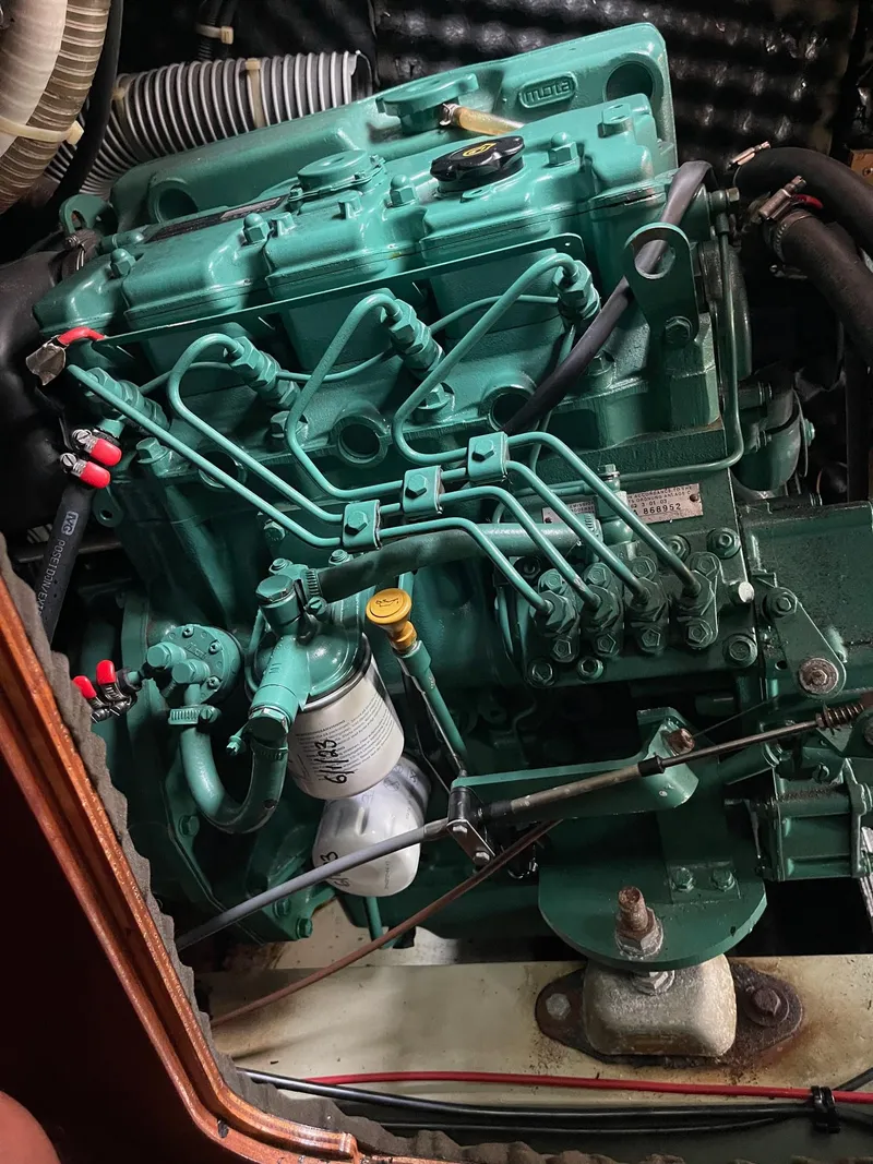 Slide: The Image of Engine of a 2003 Beneteau 423 sailboat, showcasing intricate mechanical components. - 19