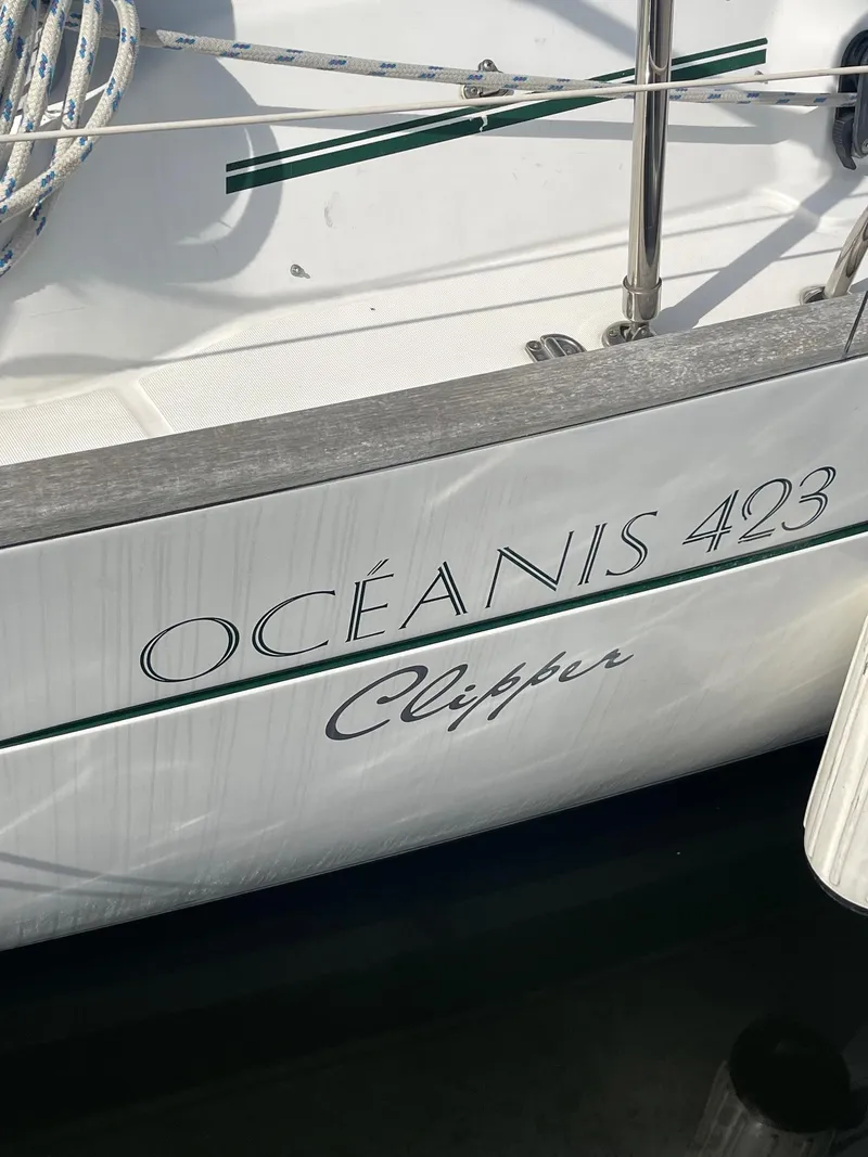 Slide: The Image of Beneteau Oceanis 423 Clipper sailboat, 2003 model, docked with visible branding. - 2