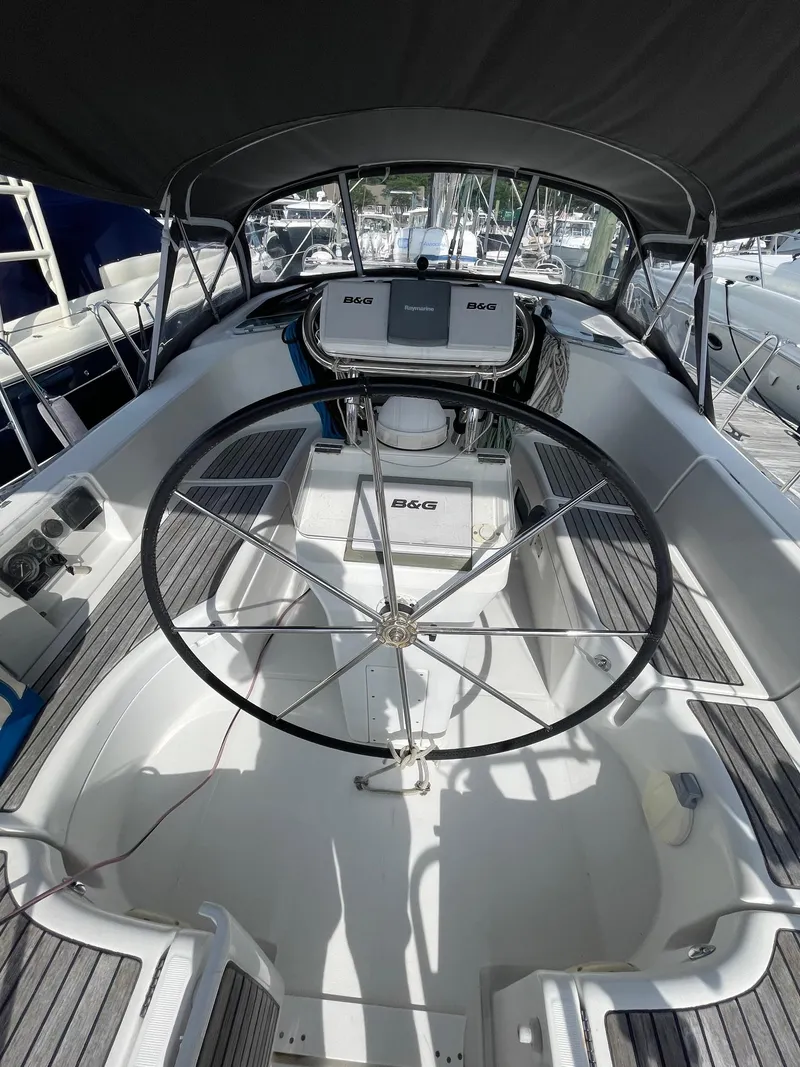 Slide: The Image of 2003 Beneteau 423 sailboat cockpit with steering wheel and navigation equipment. - 5