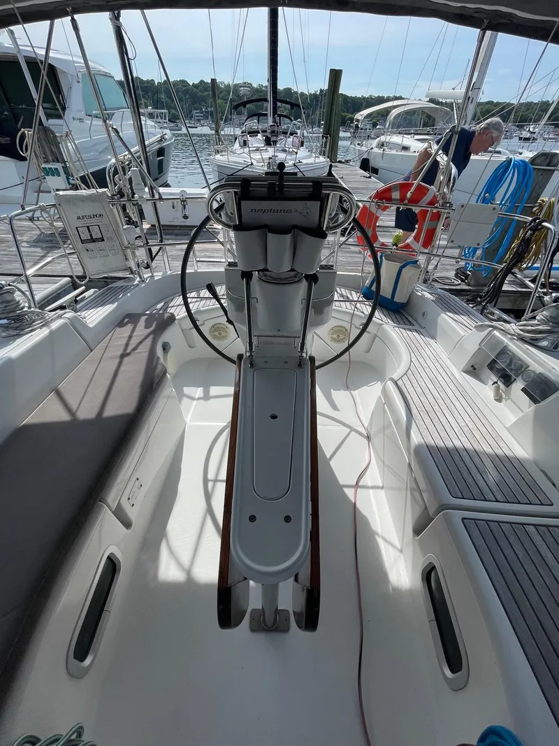 Slide: The Image of Cockpit of a 2003 Beneteau 423 sailboat, featuring steering wheel and nautical equipment. - 6