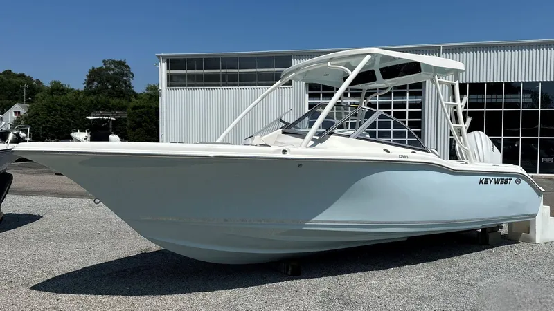 The Image of 2026 Key West 239 DFS boat displayed outdoors near a modern building. - 0