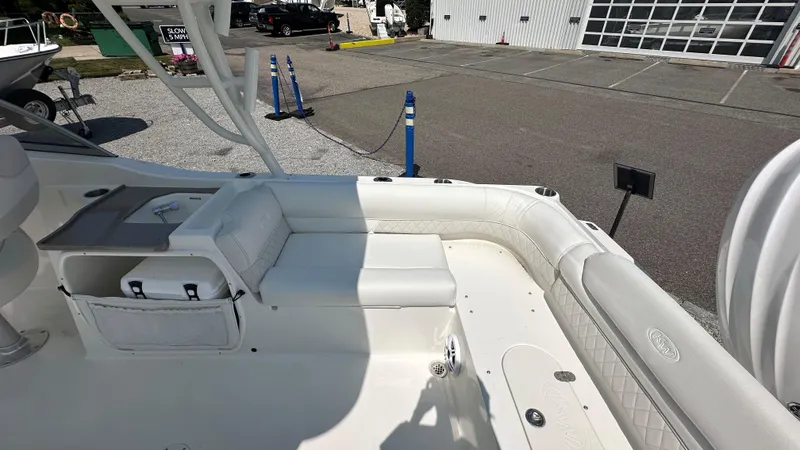 Slide: The Image of 2026 Key West 239 DFS boat interior with white seating and storage compartments. - 11