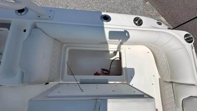 Slide: The Image of Interior view of 2026 Key West 239 DFS boat, featuring white seating and storage compartment. - 13